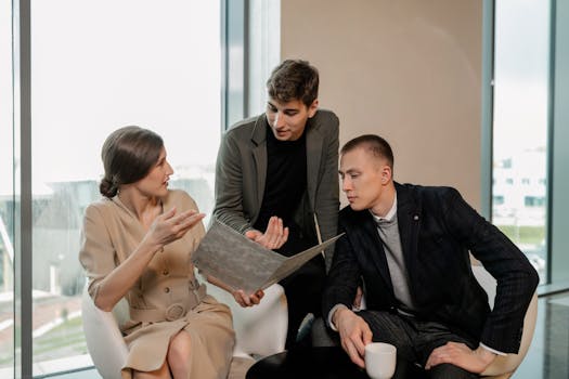 Group of professionals discussing business strategy together inside a modern office.